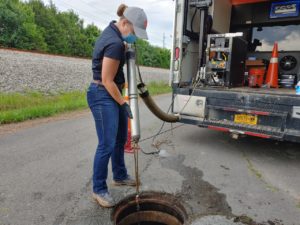 Mack from Electro Scan lowers probe into the manhole